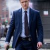 Actor Ben McKenzie TV Drama Gotham James Gordon Wearing a Stylish Blue Suit he holding Gun in a Right-hand