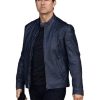 Tom Cruise Wearing A Blue Jacket in Mission Impossible and holding cell phone in right hand