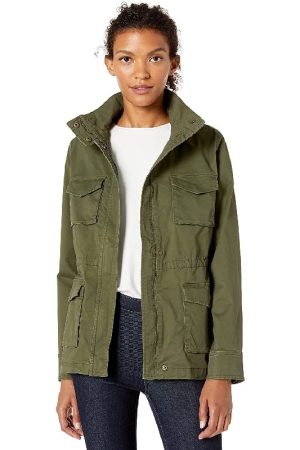 A Yong Girl Wearing A White Top and Outwear is Green Cotton Jacket and the bottom is Black paint