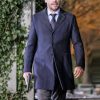 Paul Blackthorne Wearing A Navy Blue Color Styish Wool Coat In Dama Series Arrow he holding a gun in right hand
