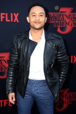 Tahj Mowry Wearing A Black Leather Jacket at an event for Stranger Things 