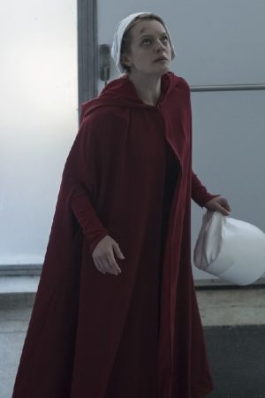 Actress Elisabeth Moss Wearing Maroon Cape In The Handmaid's Tale as June Osborne