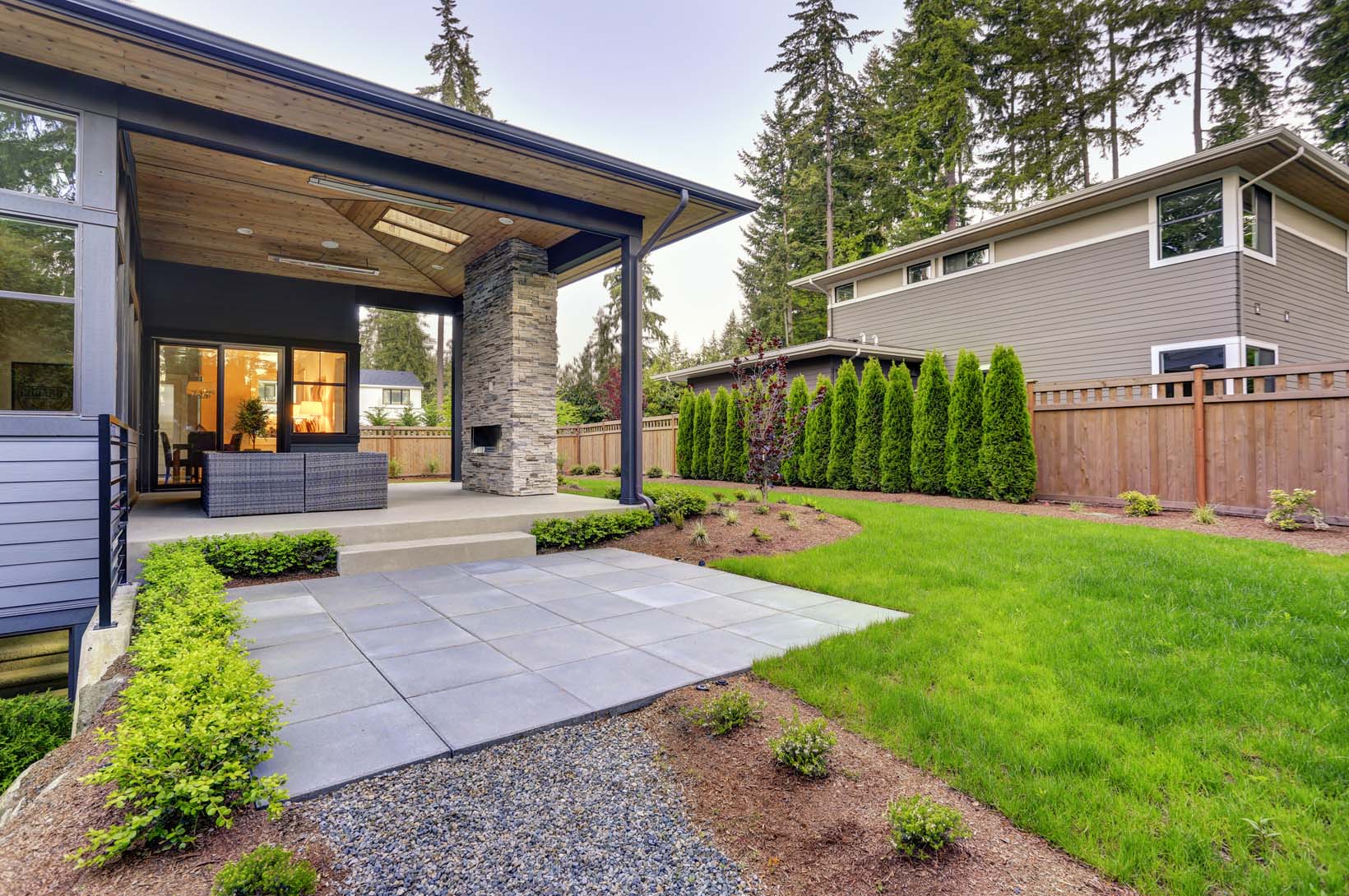 New Modern Home Features A Backyard With Patio