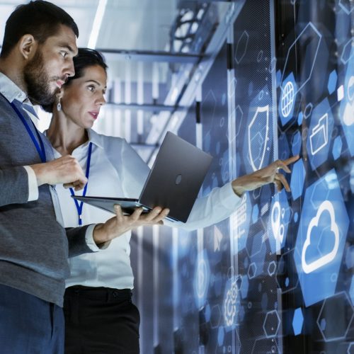 Male,It,Specialist,Holds,Laptop,And,Discusses,Work,With,Female
