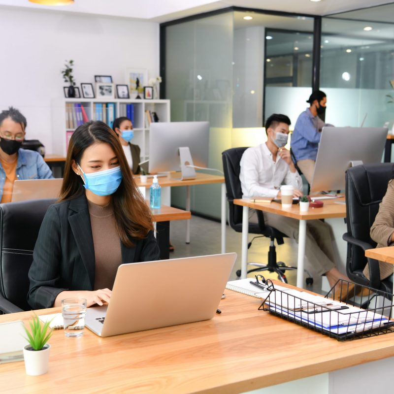 Asian,Office,Workers,Wearing,Face,Masks,Working,In,New,Normal